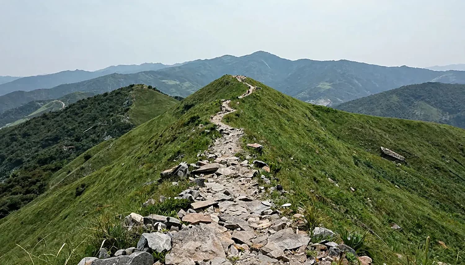 A narrow path along a ridge toward the summit.